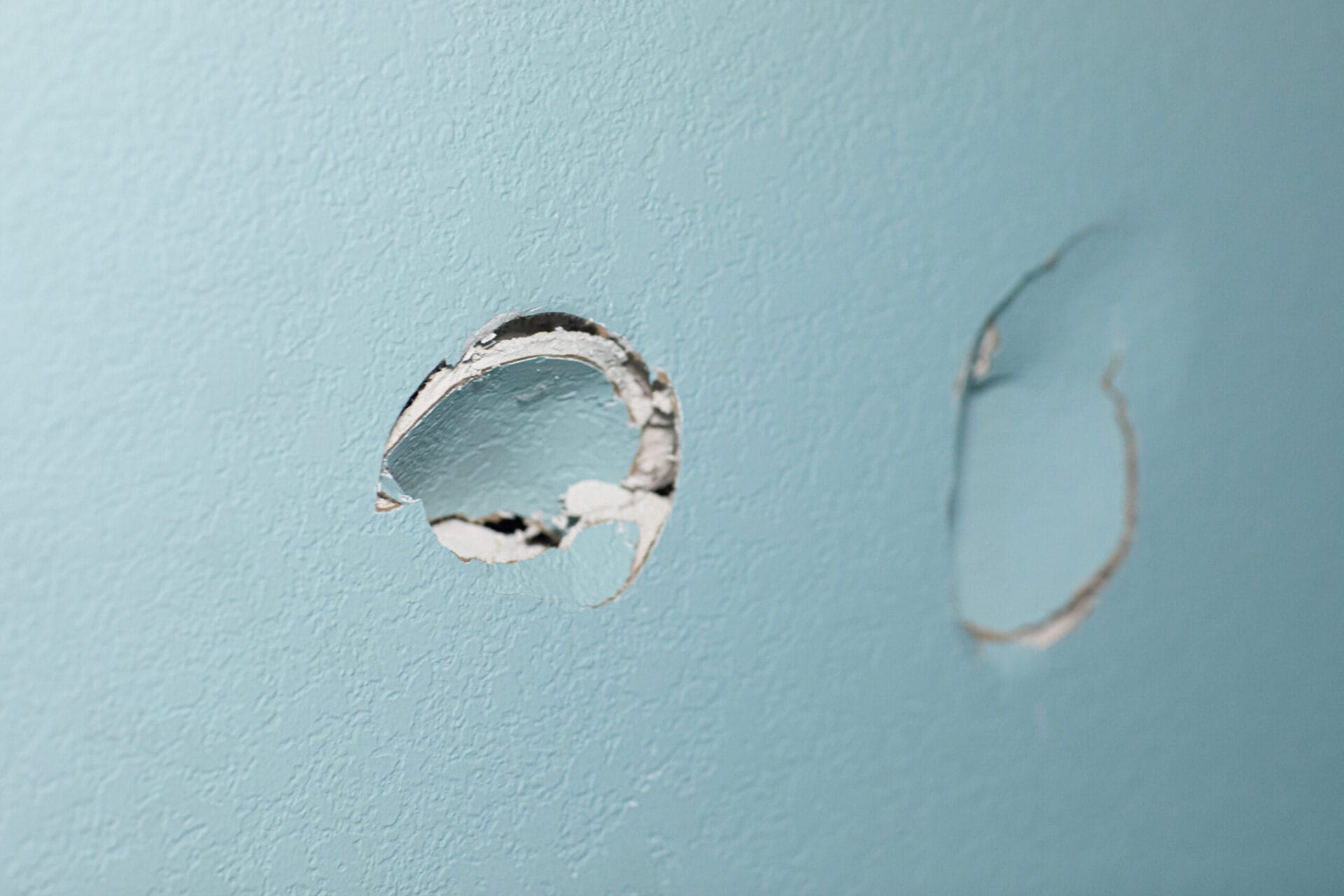 A wall with a hole in it that needs to be fixed.