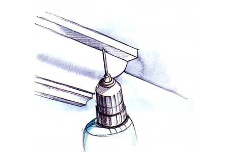 An illustration of a drill being used to make a pilot hole.