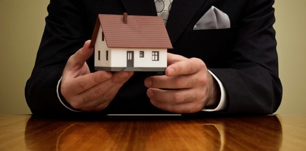 a real estate broker holding a model home