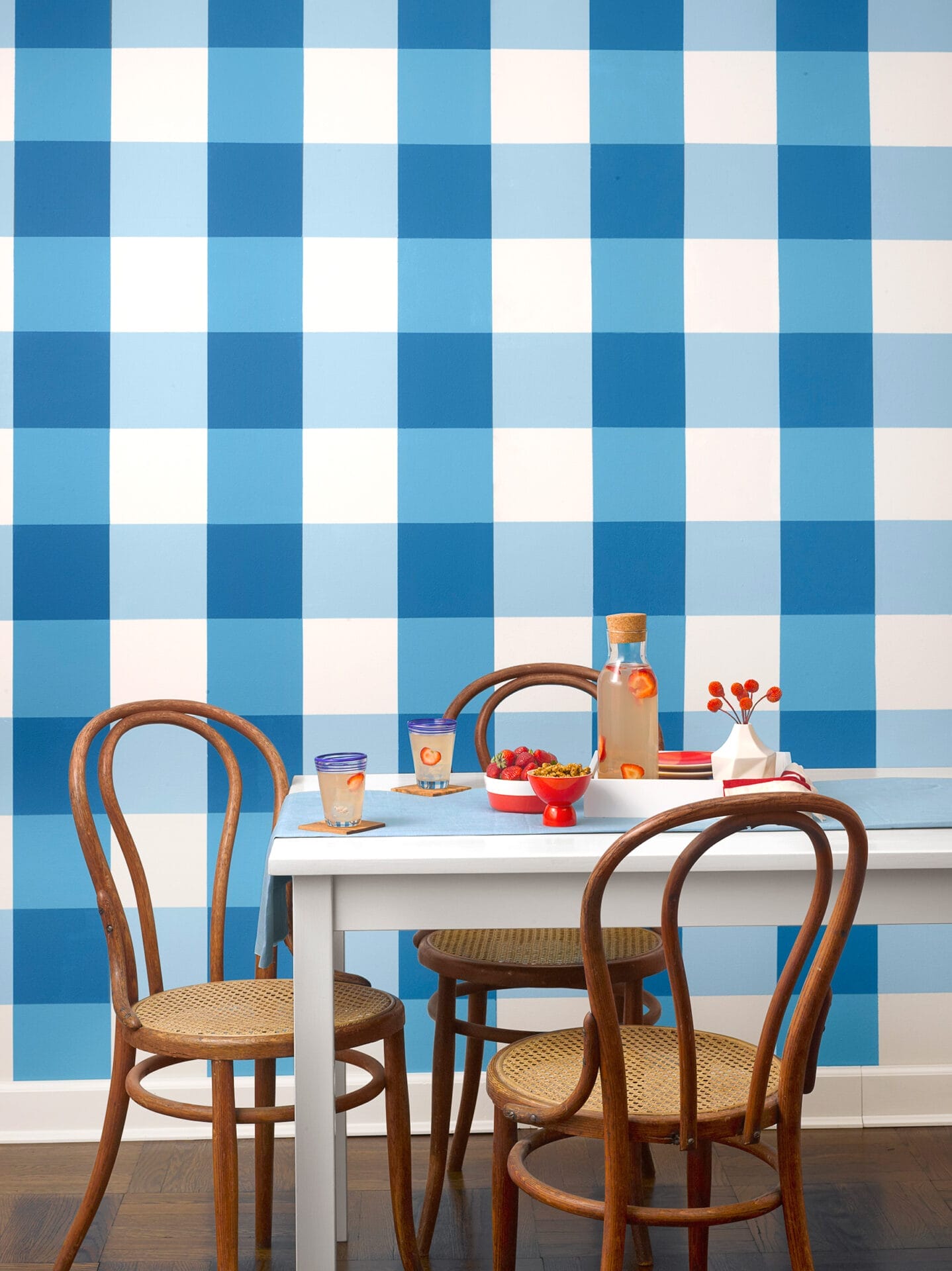 Dining room with gingham pattern checks painted on the wall.