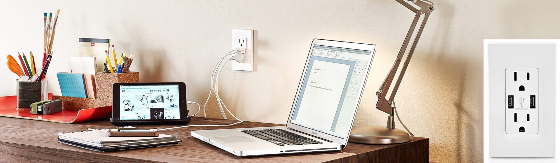 An outlet with a USB charging port near a desk.