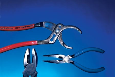 A set of three pliers on a blue background