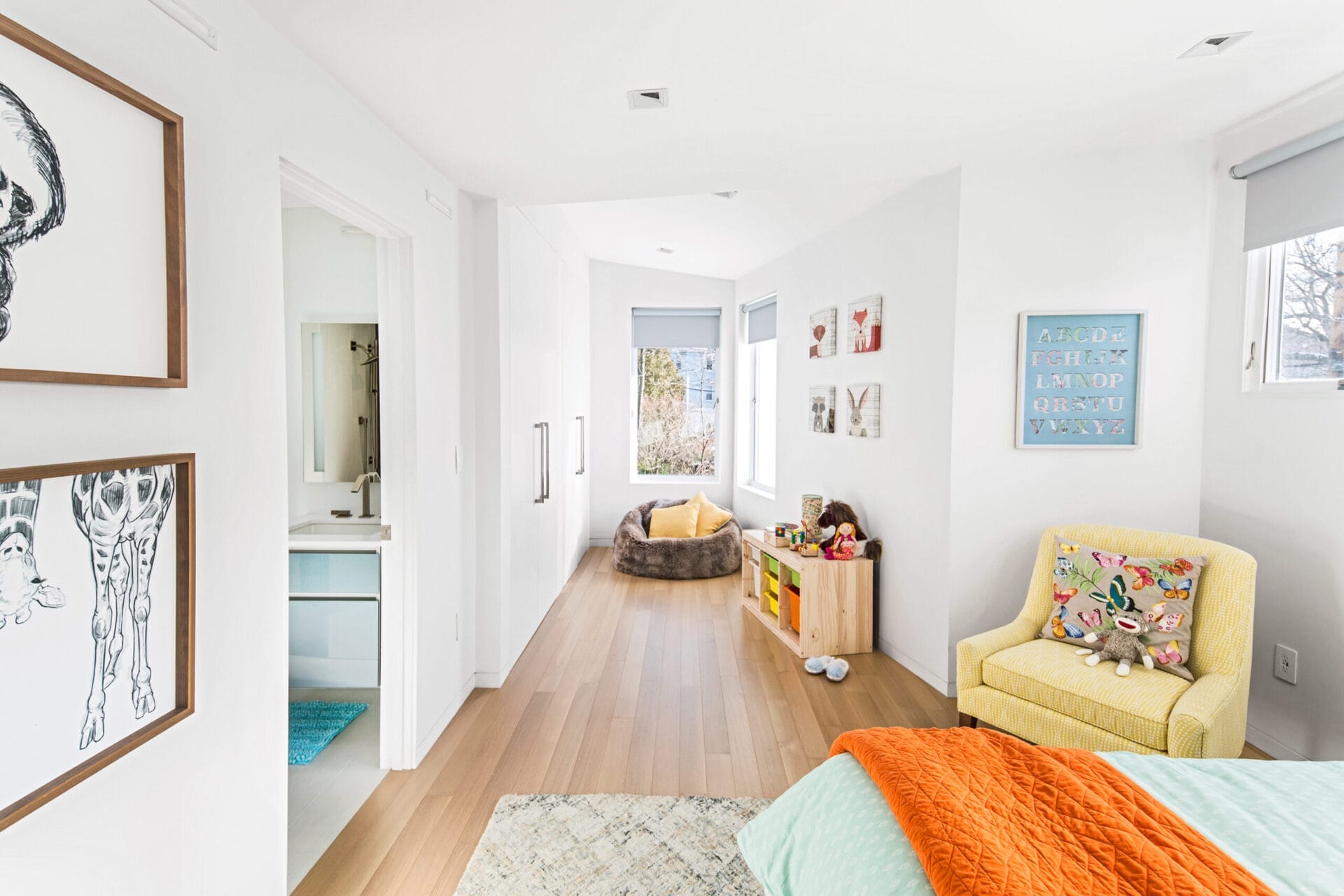 Nisa's windowed reading nook with upholstered chair and storage.