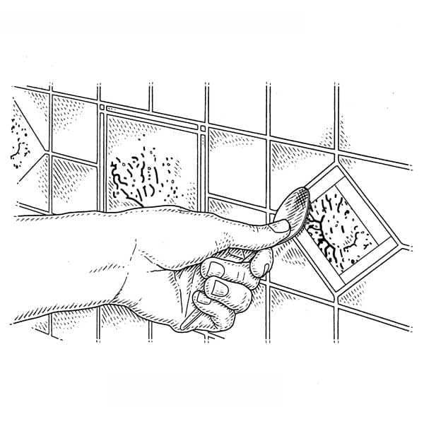 Illustration of the grout around decorative tiles being smoothed.