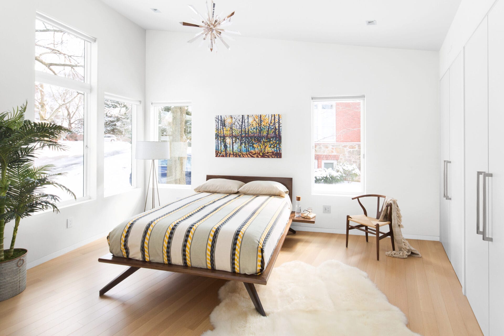 Master bedroom with sloped ceiling and pale oak flooring throughout.
