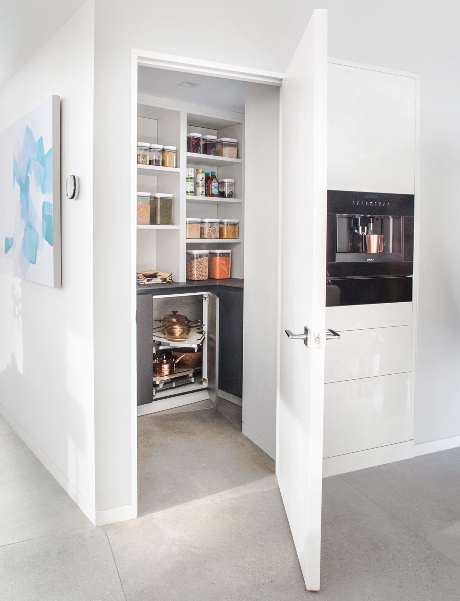 Built-in coffee center and pantry storage in dining area cabinetry.