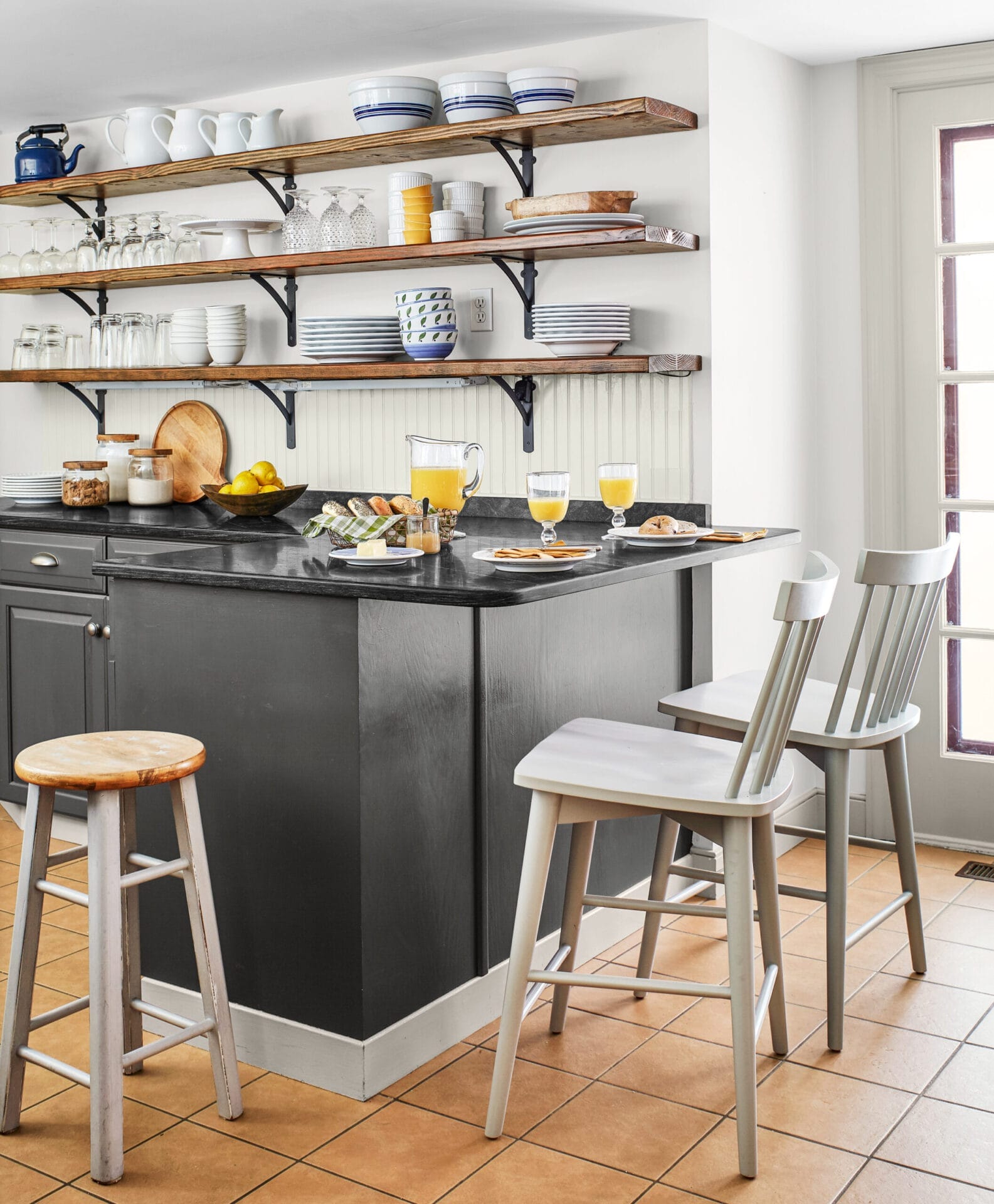 Open shelving with matching dishes in the kitchen.