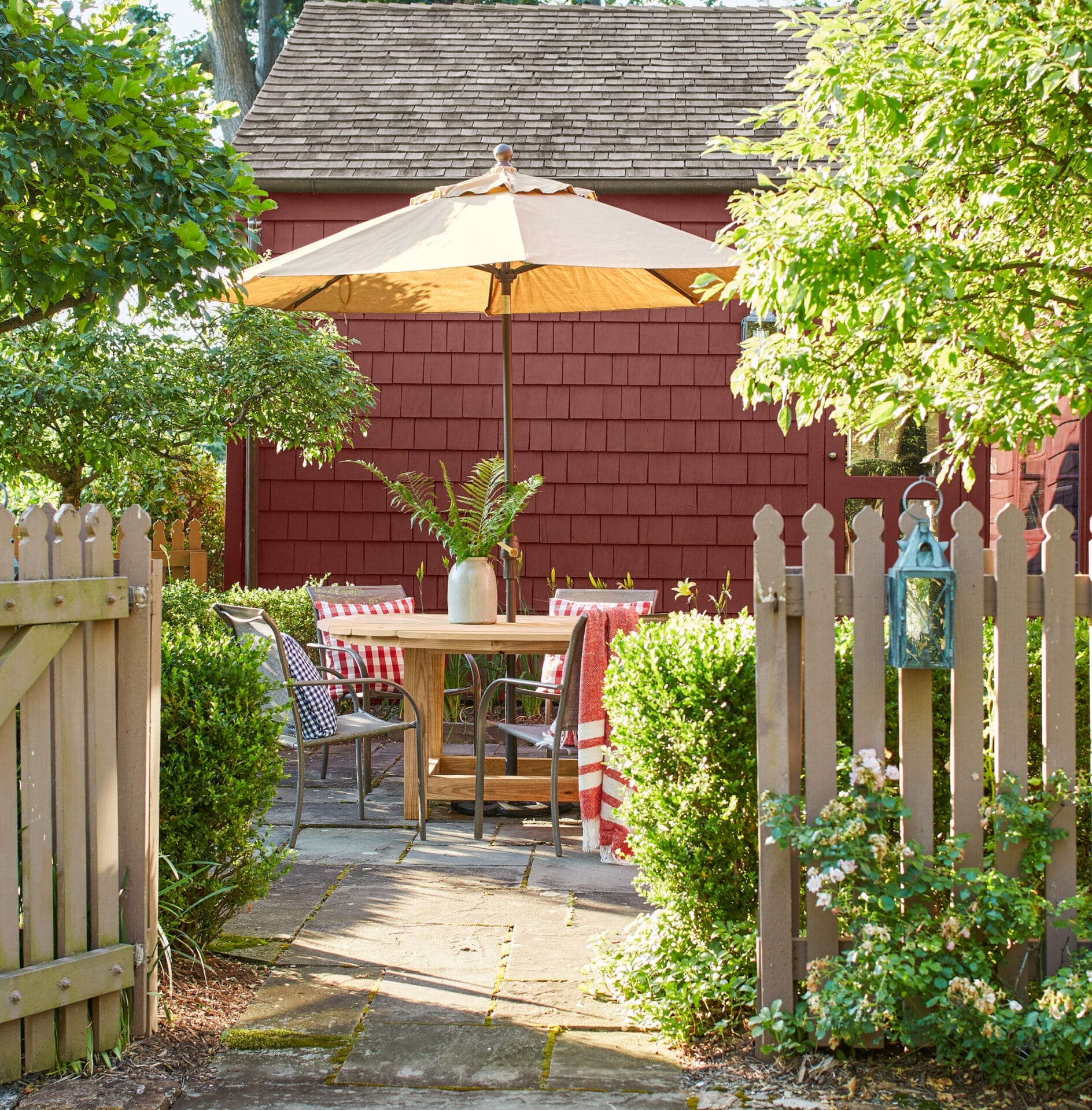 A patio dining area surrounded by a picket fence.