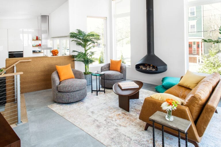 Modern split-level living room with floating fireplace and steel cable railings.