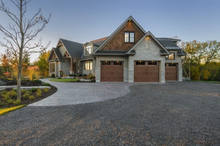 Image of a stone house with a craftsman garage door