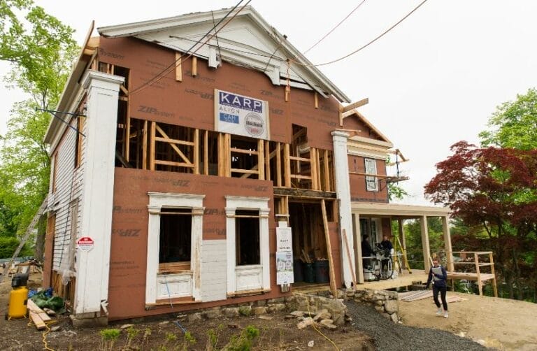 1840 Greek Revival farmhouse facade undergoing restoration in New Canaan.