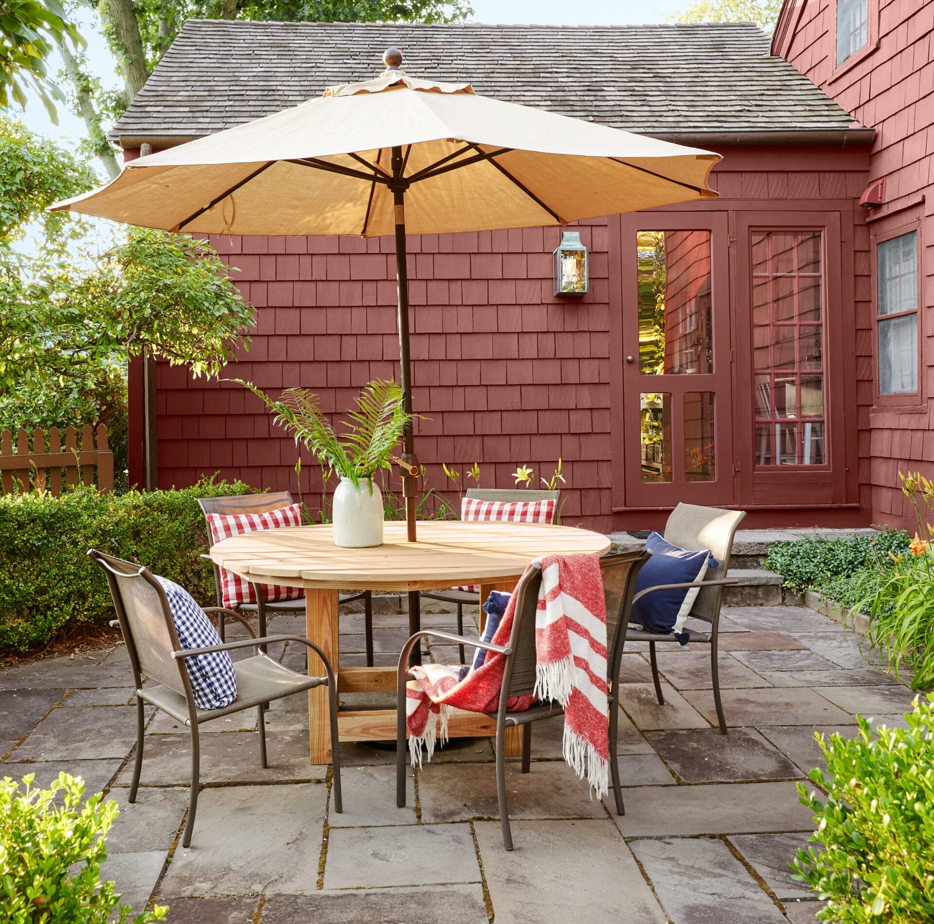 A patio dining set with an umbrella.