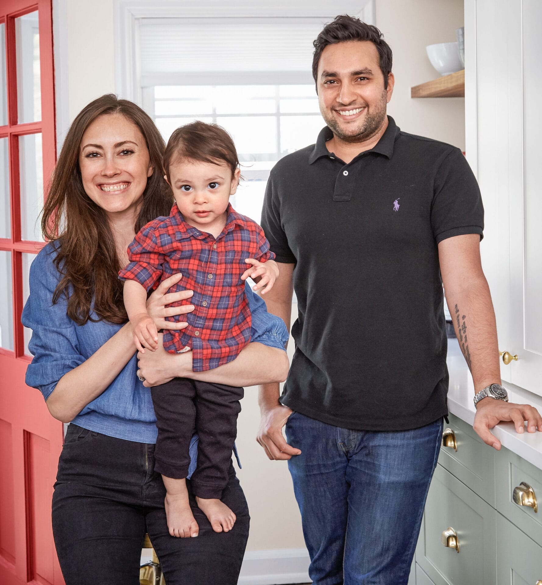 Family portrait of Melissa, Dheeraj and son Dhilan in renovated kitchen.