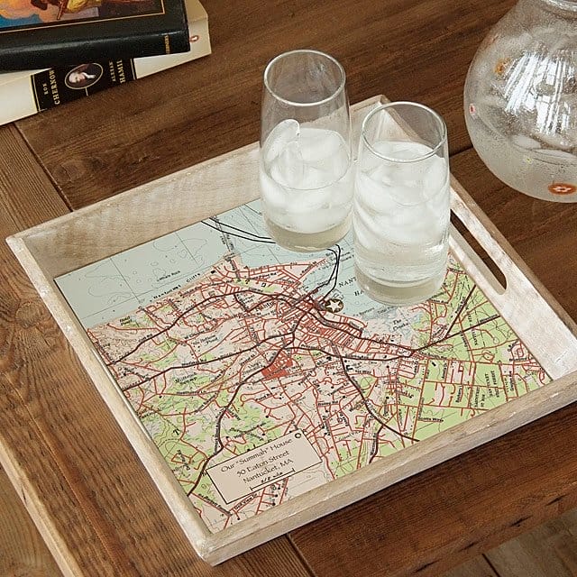 A custom map serving tray holding two glasses of water.