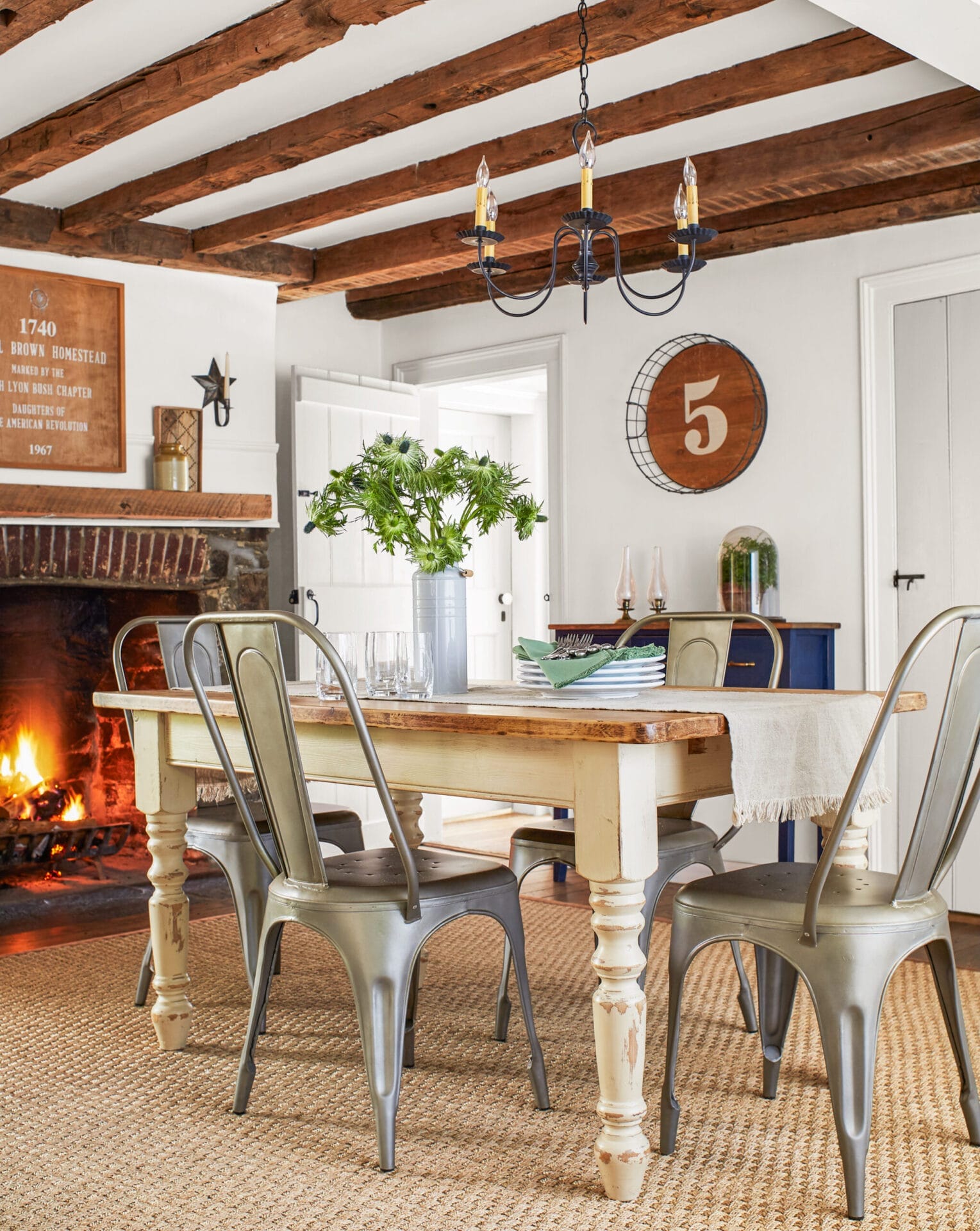 Original timber beams above a dining room table.