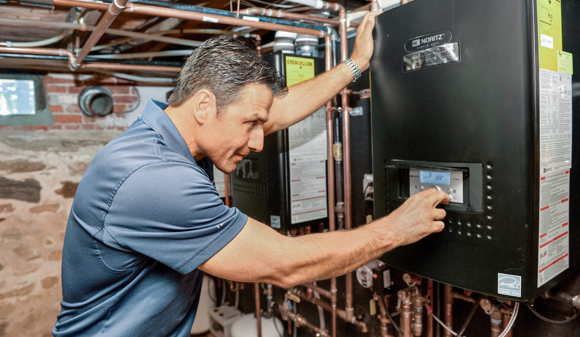 A man setting a tankless water heater.
