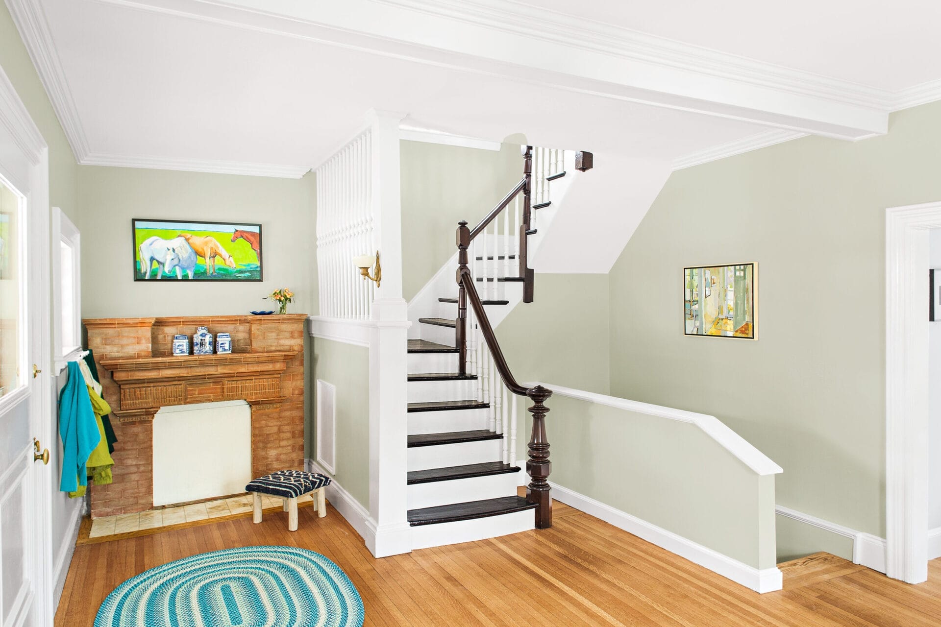 Entry fireplace with stripped mantel.