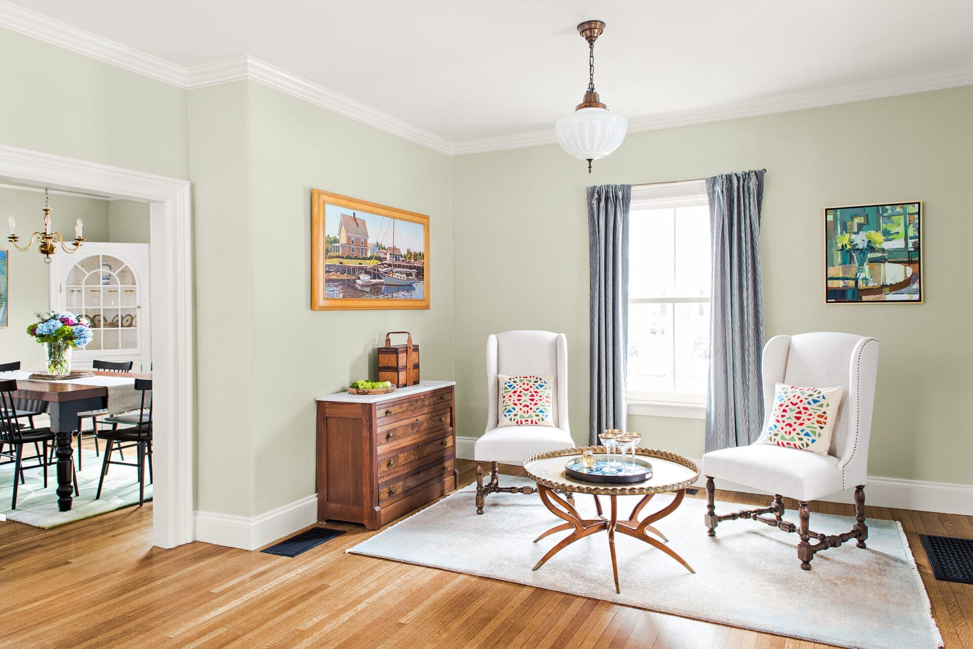 Front parlor with vintage light fixture and original wood floors.