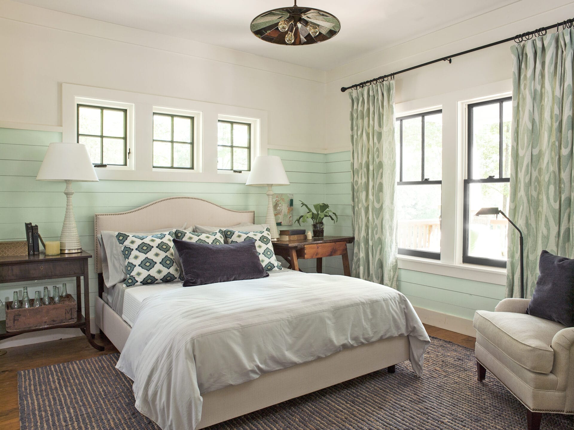 A bedroom with a green and brown color scheme.