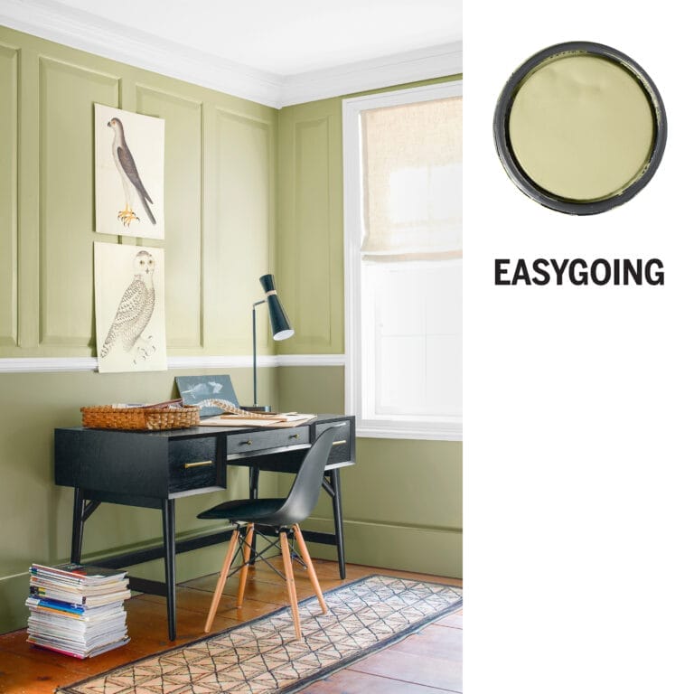 Easygoing paneled dining room with cucumber green walls and black mid-century furniture.