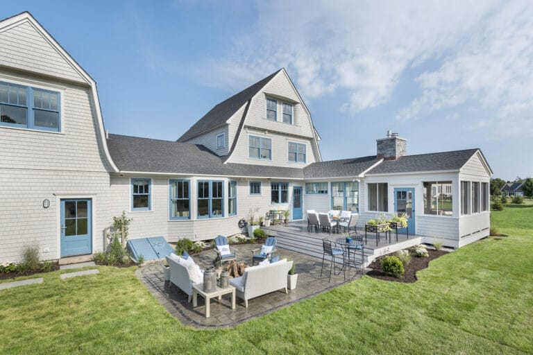 Large white house with two-level PVC deck.