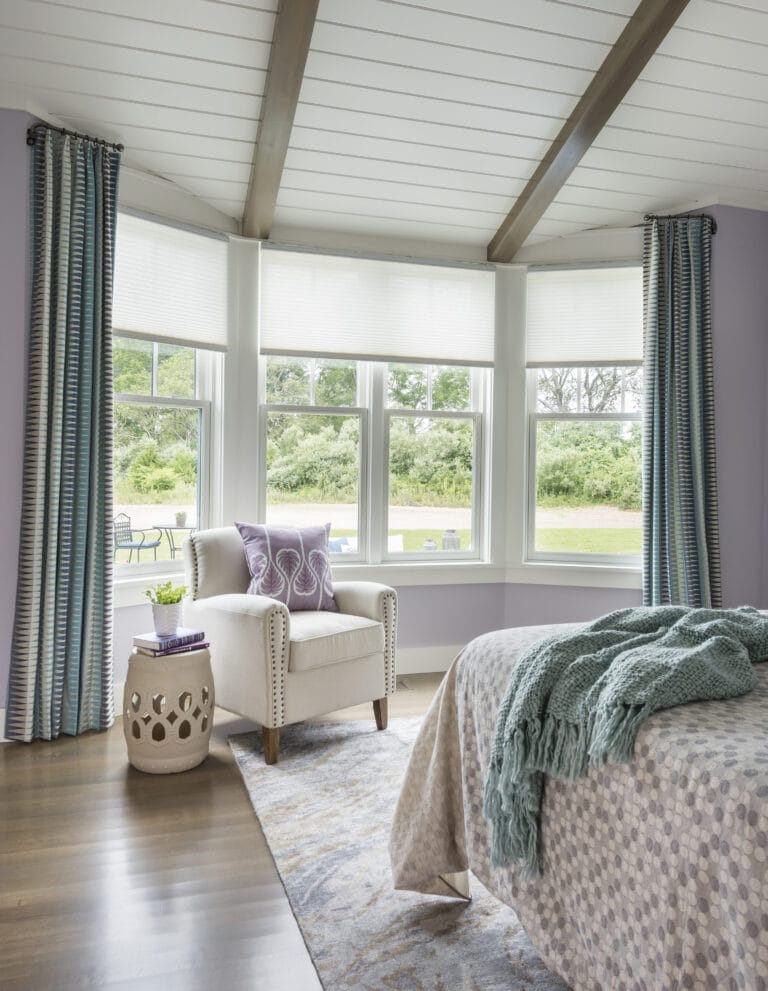 Bay window seating area with battery-powered remote-controlled shades.
