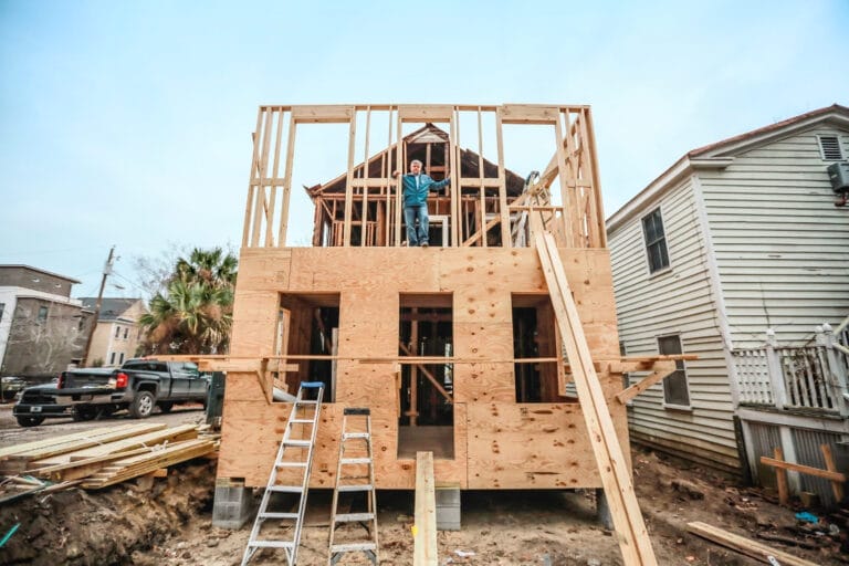 Tom Silva inspecting wooden framing for two-story addition during the historic Charleston house restoration.
