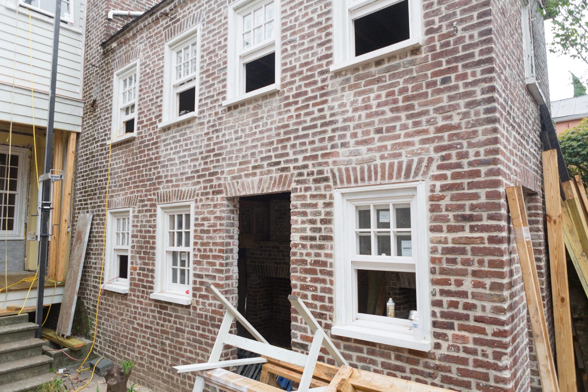 Kitchen house exterior showing repointed brick walls with lime-based mortar.