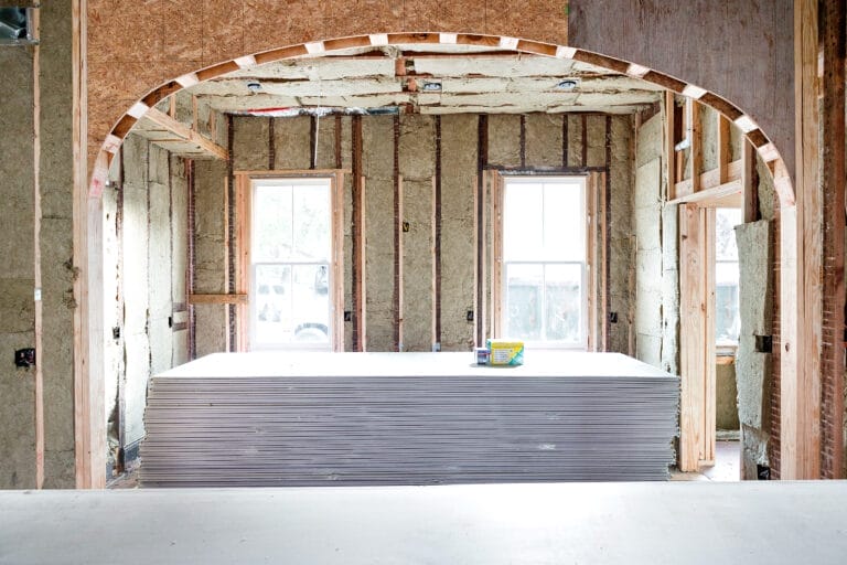 An archway under construction to visually separate the kitchen and dining room.