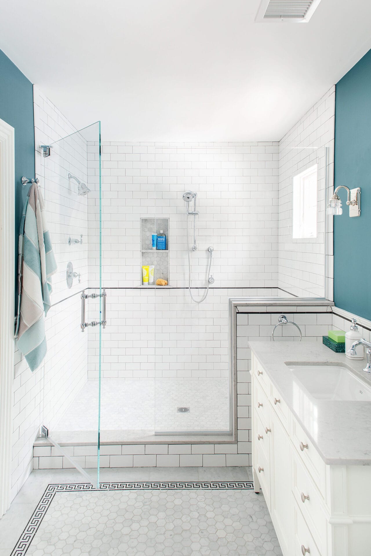 Master bathroom with gray-blue walls and white subway tile.