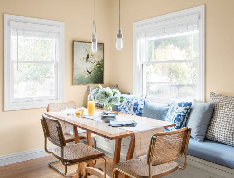 Corner dining banquette with built-in seating and dual windows.