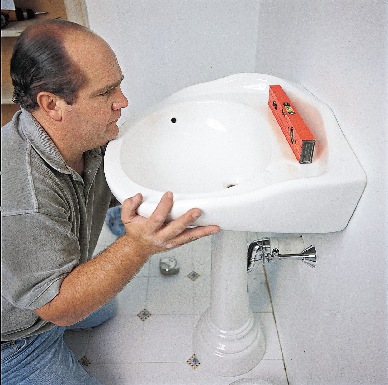 A man works with a sink.