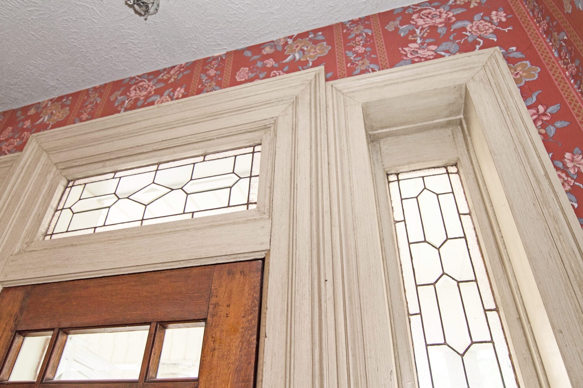 Leaded-glass sidelights and transoms around the front door.