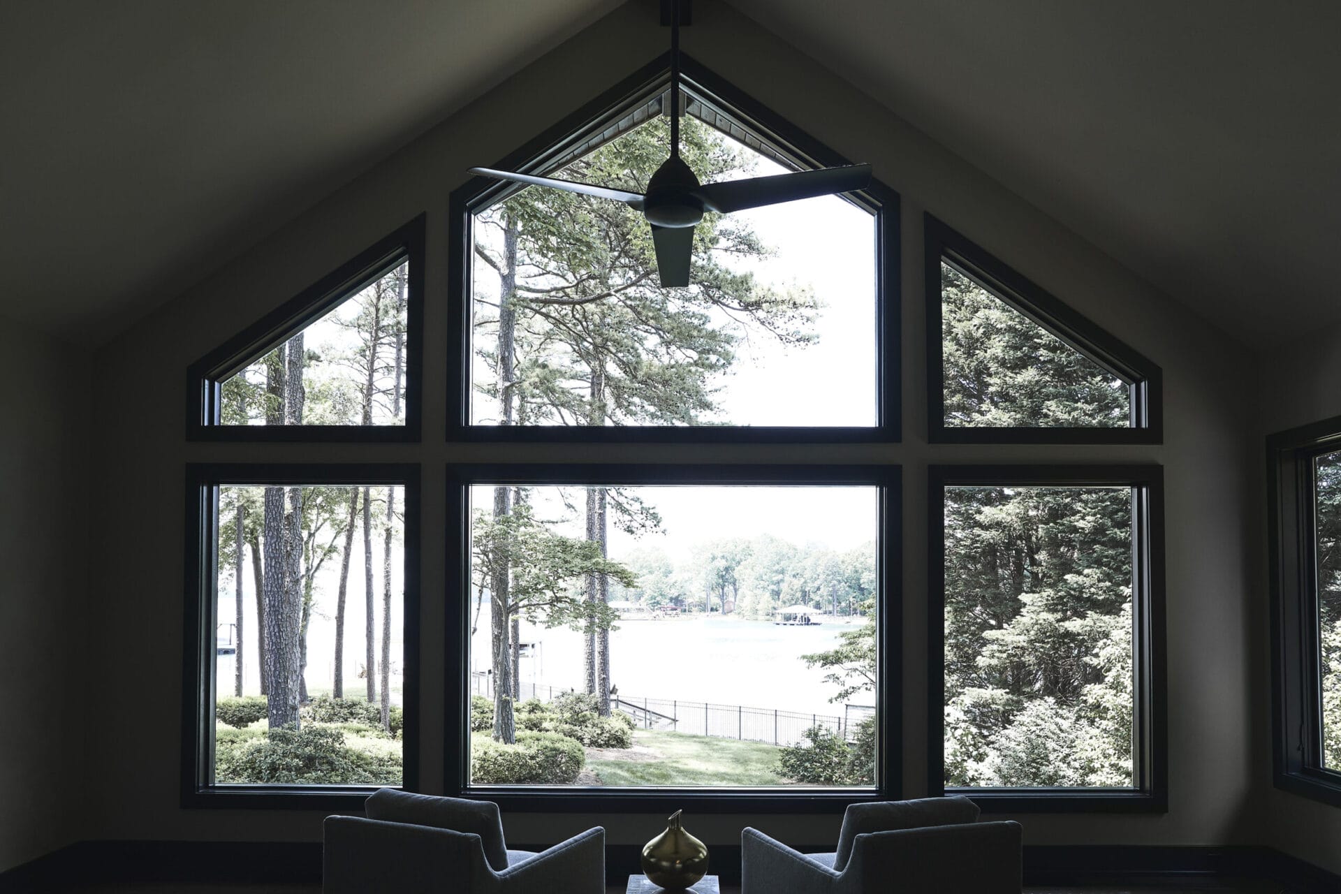 A large set of windows looking over a scenic nature view.