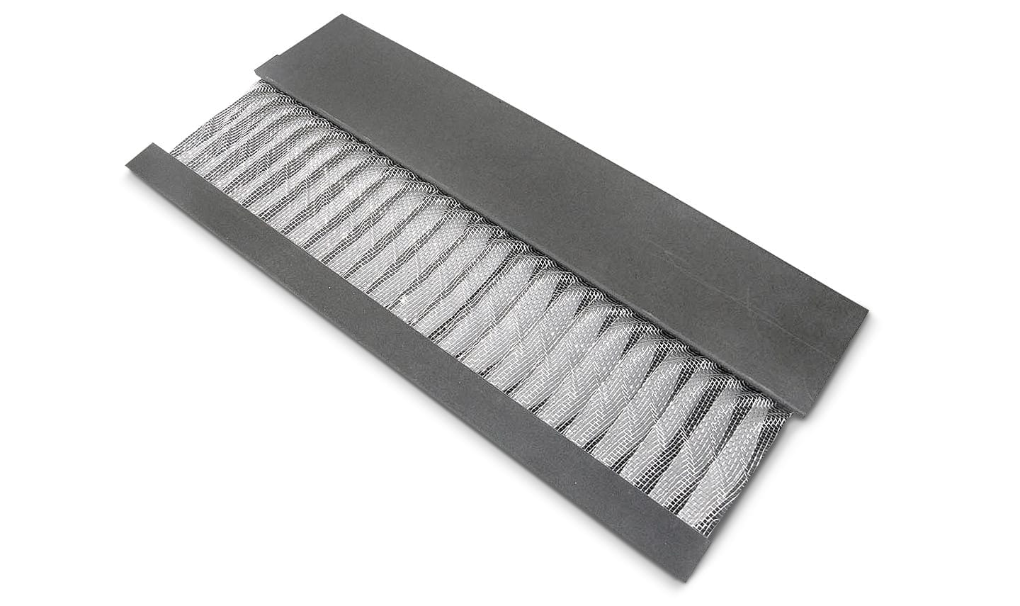 Curved metal gutter guard with S-shaped ridges and zinc strips.