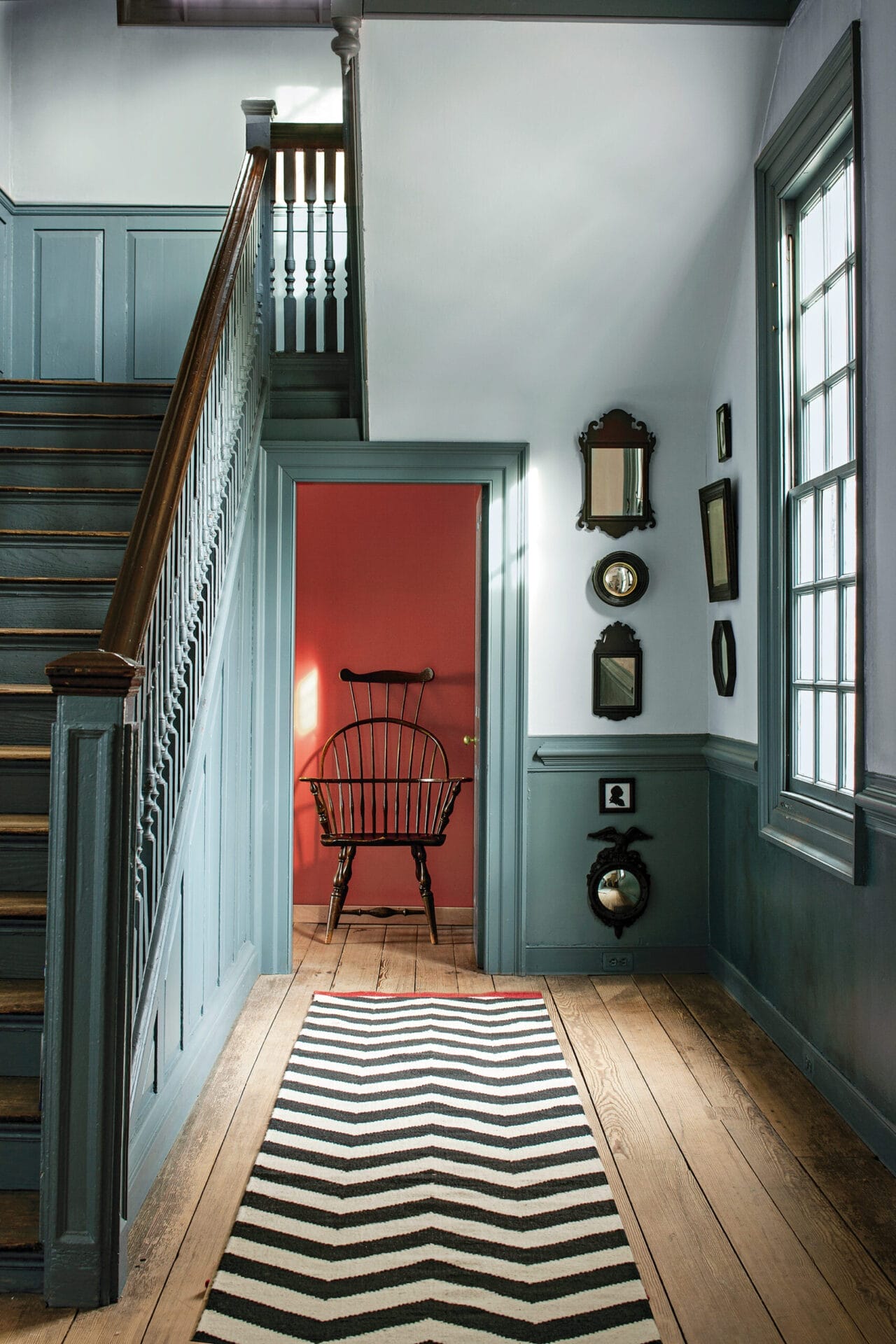 Colonial room featuring subtle blue walls with darker trim in monochromatic scheme.