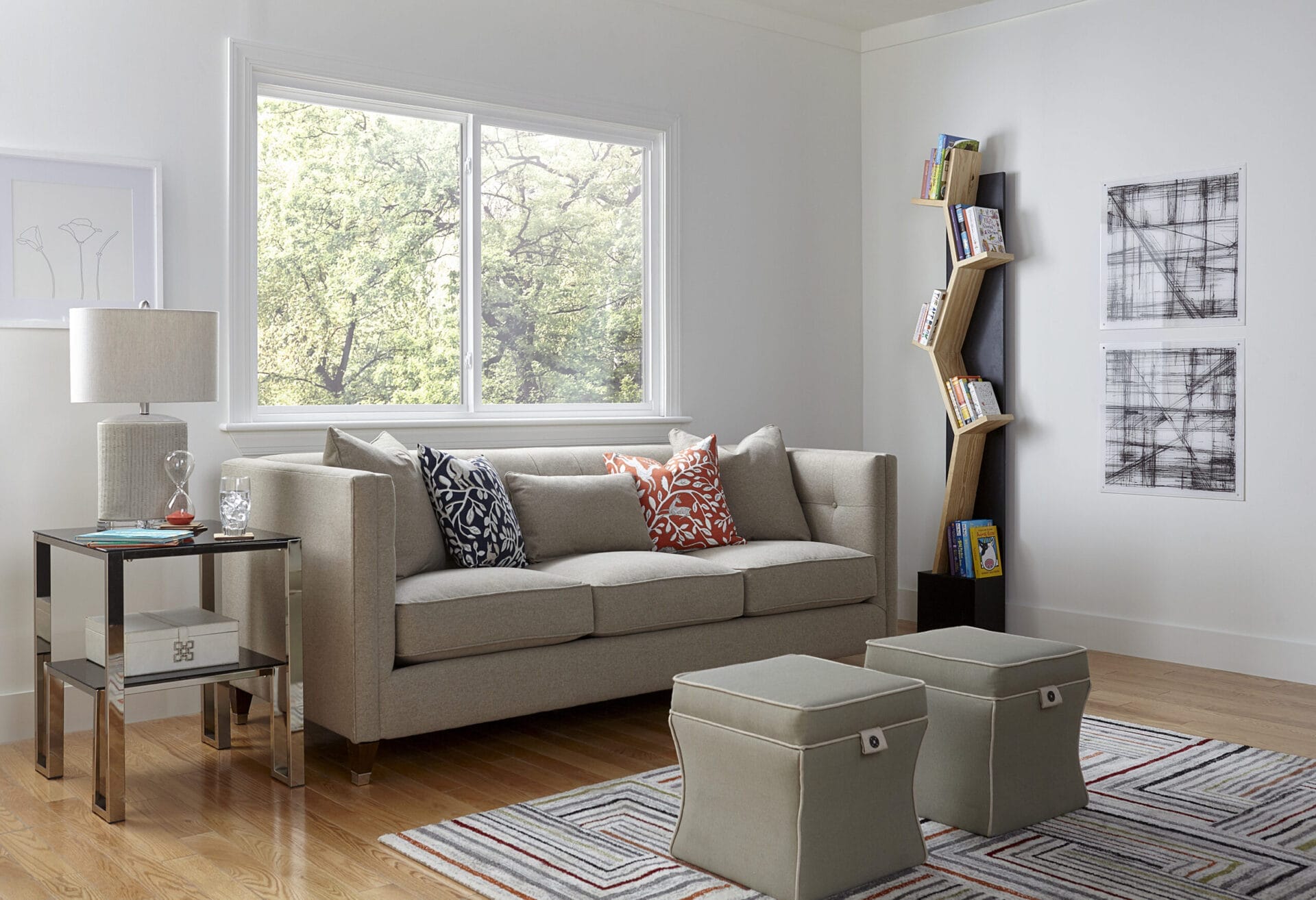A room with a couch in front of a large window.