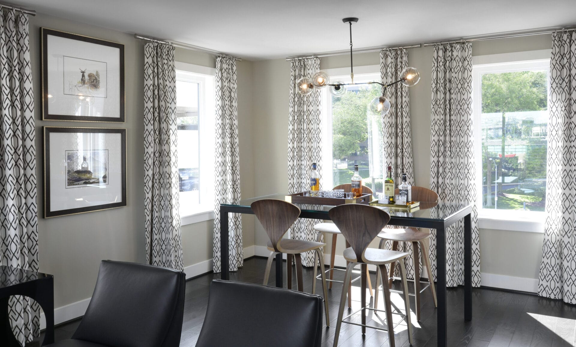 A dining room with 3 large windows.