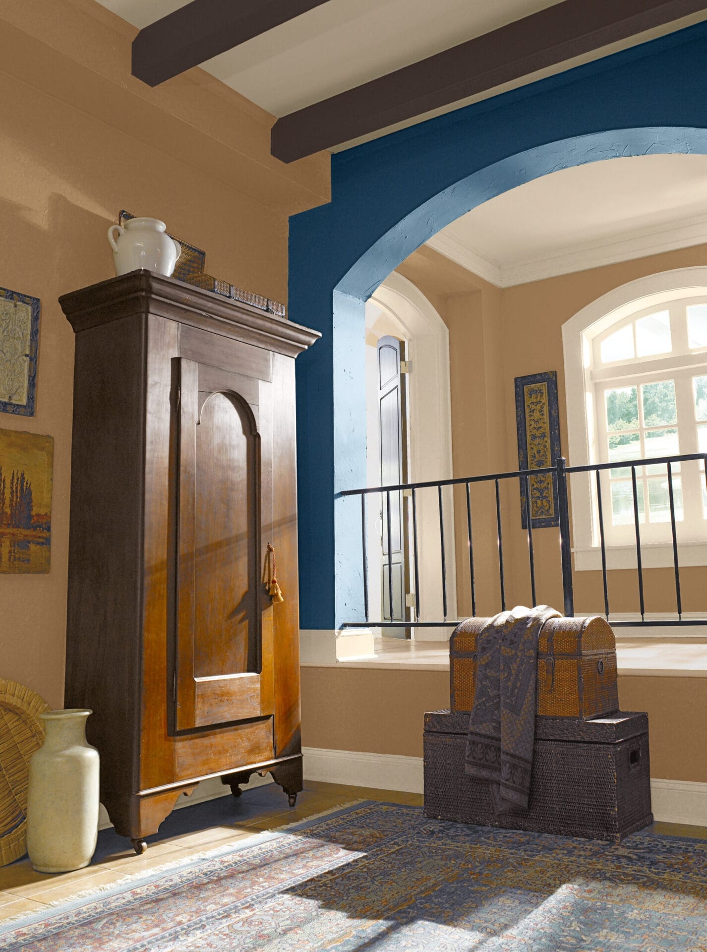 Spanish Revival interior featuring dark beams with rich brown and gold color palette.