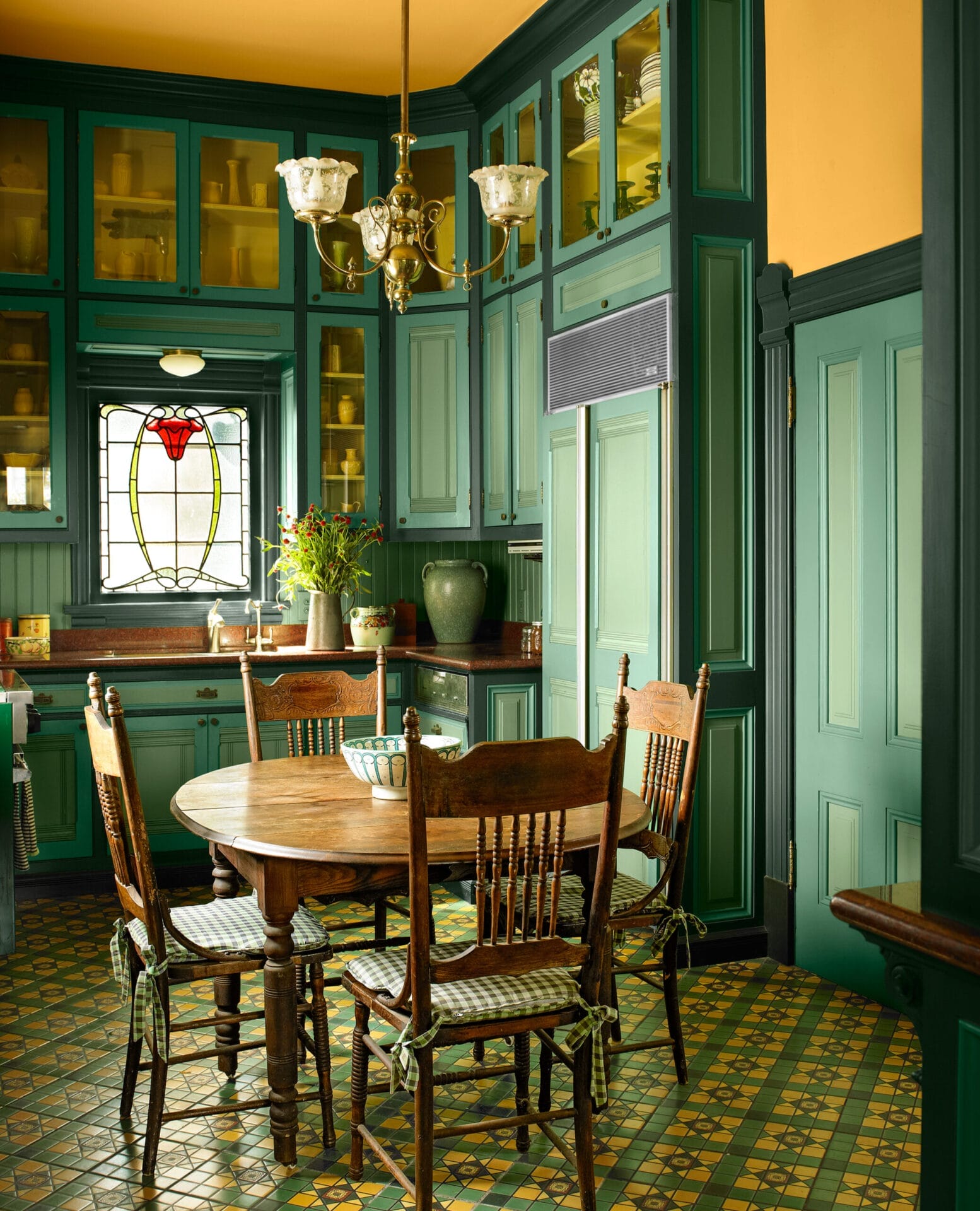 Victorian kitchen featuring layered bright green cabinetry with yellow walls and ceiling.