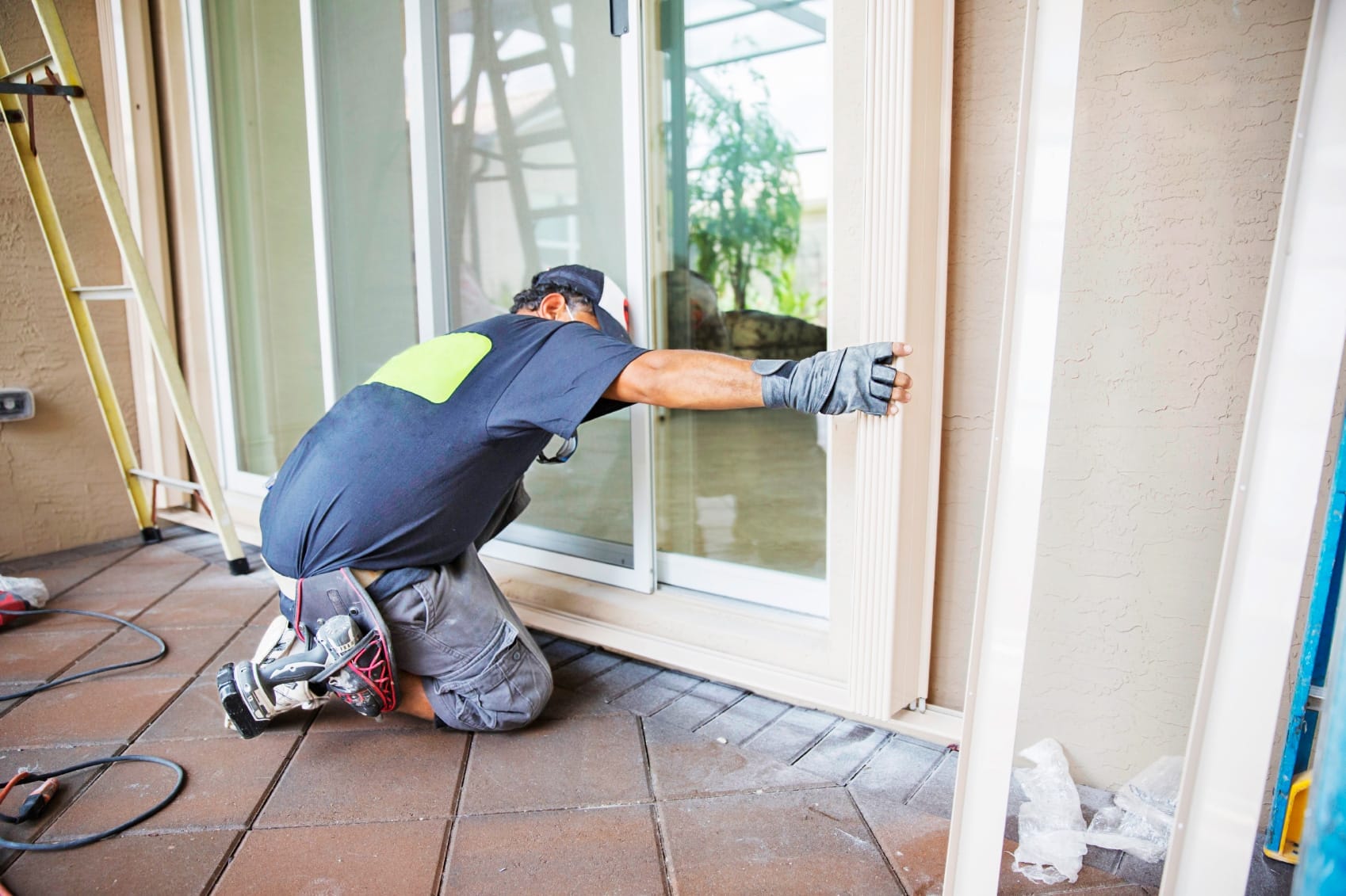 A man installs exterior French doors.