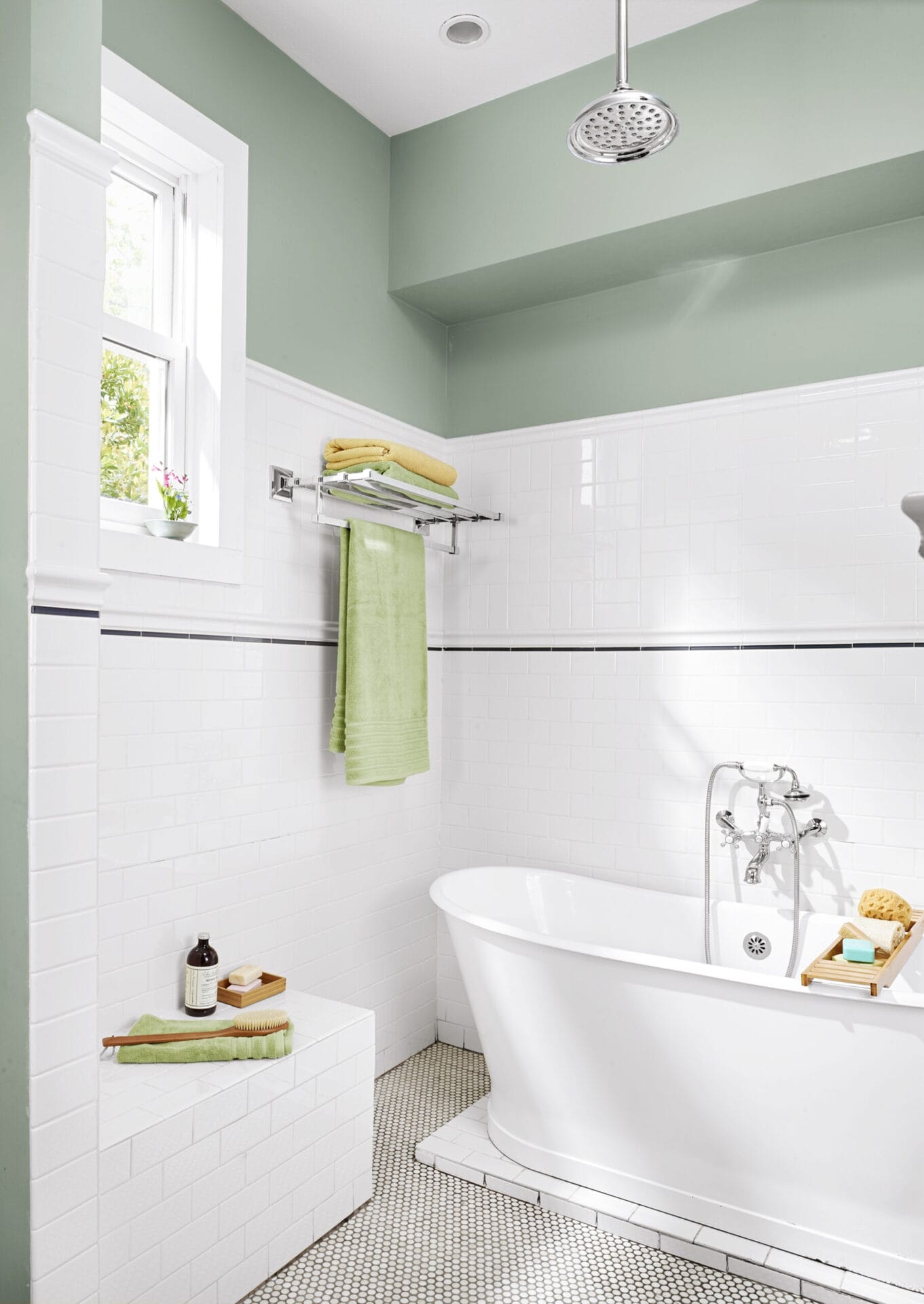 Wet-room accessories including charcoal-gray glass tile pinstripe, built-in bench, and train-style towel racks.