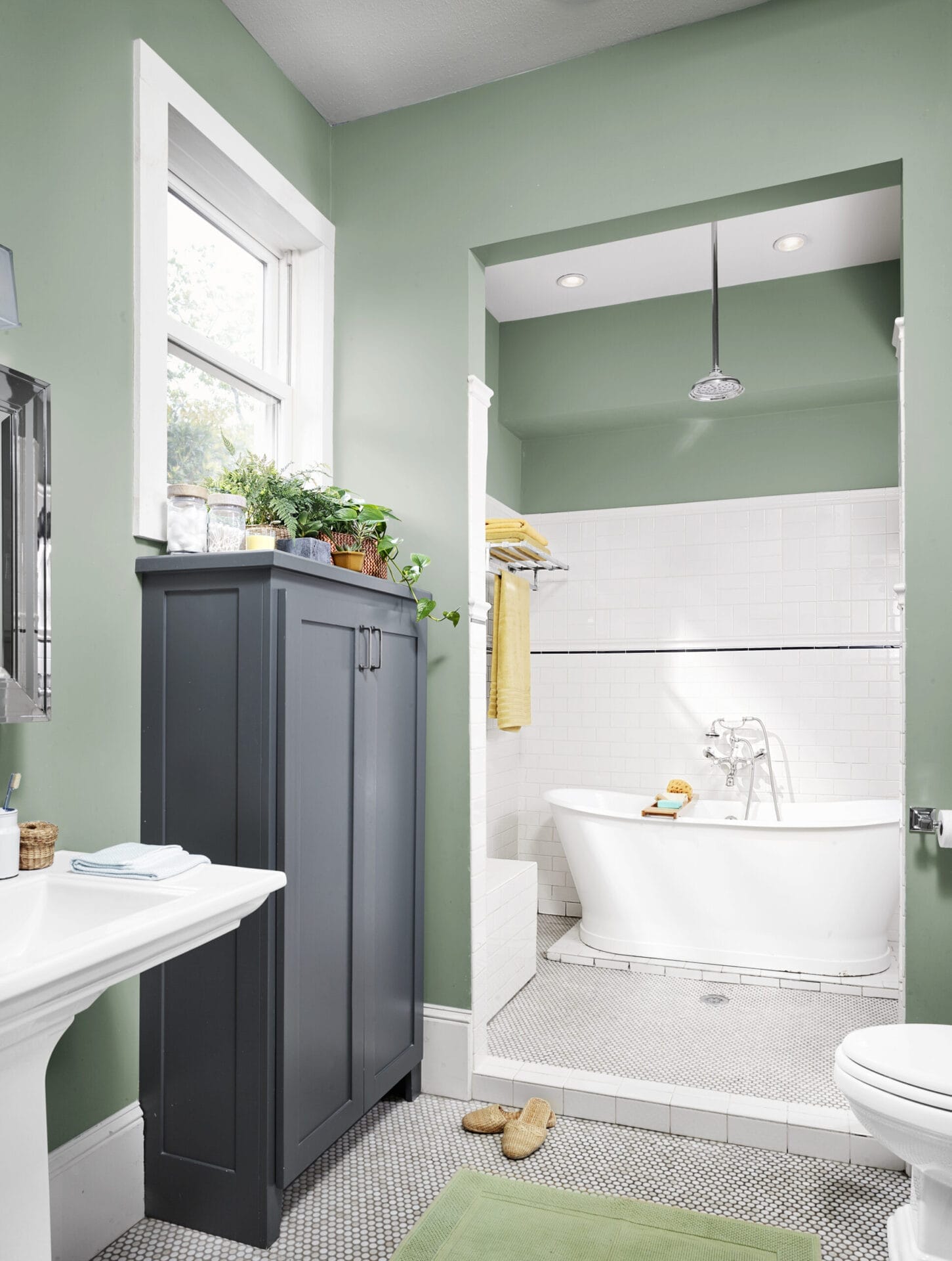Spacious wet-room bathroom with cast-iron soaking tub and rain head shower.