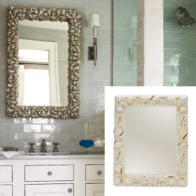 A bathroom mirror with a seashell frame.