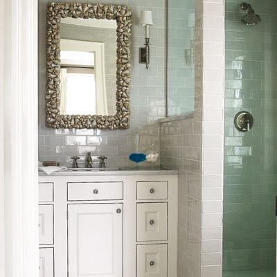 A close up of the sink and shower in a bathroom.