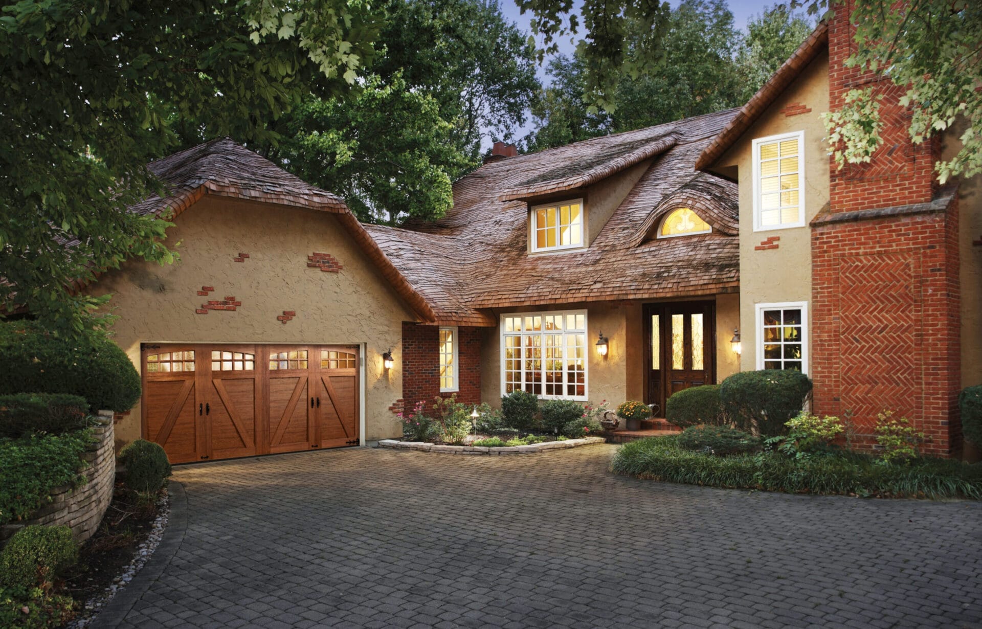 Composite carriage garage doors with arched windows.