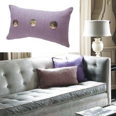 A purple pillow with capiz shells.