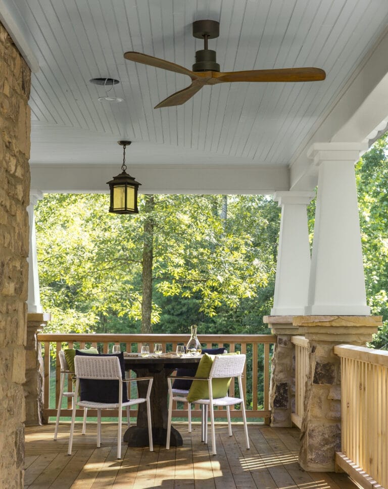 Tongue-and-groove white pine beadboard porch ceiling painted in Beach House blue with ceiling fan.