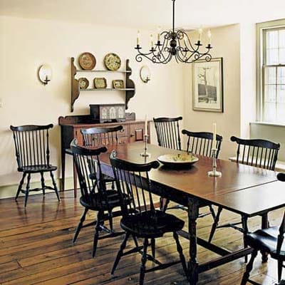 A dining room with a large table and chairs