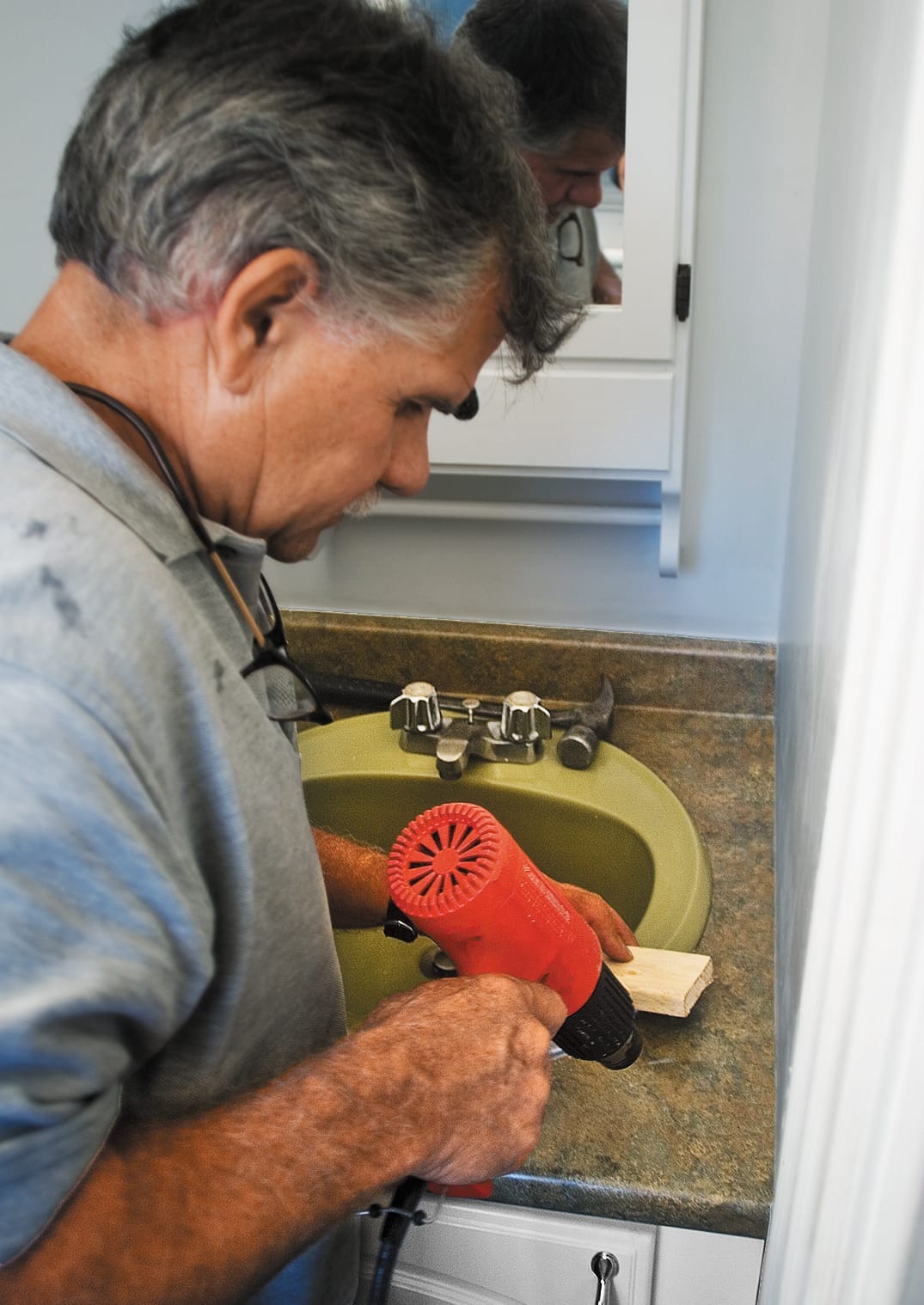 using a heat gun to soften a laminate's adhesive